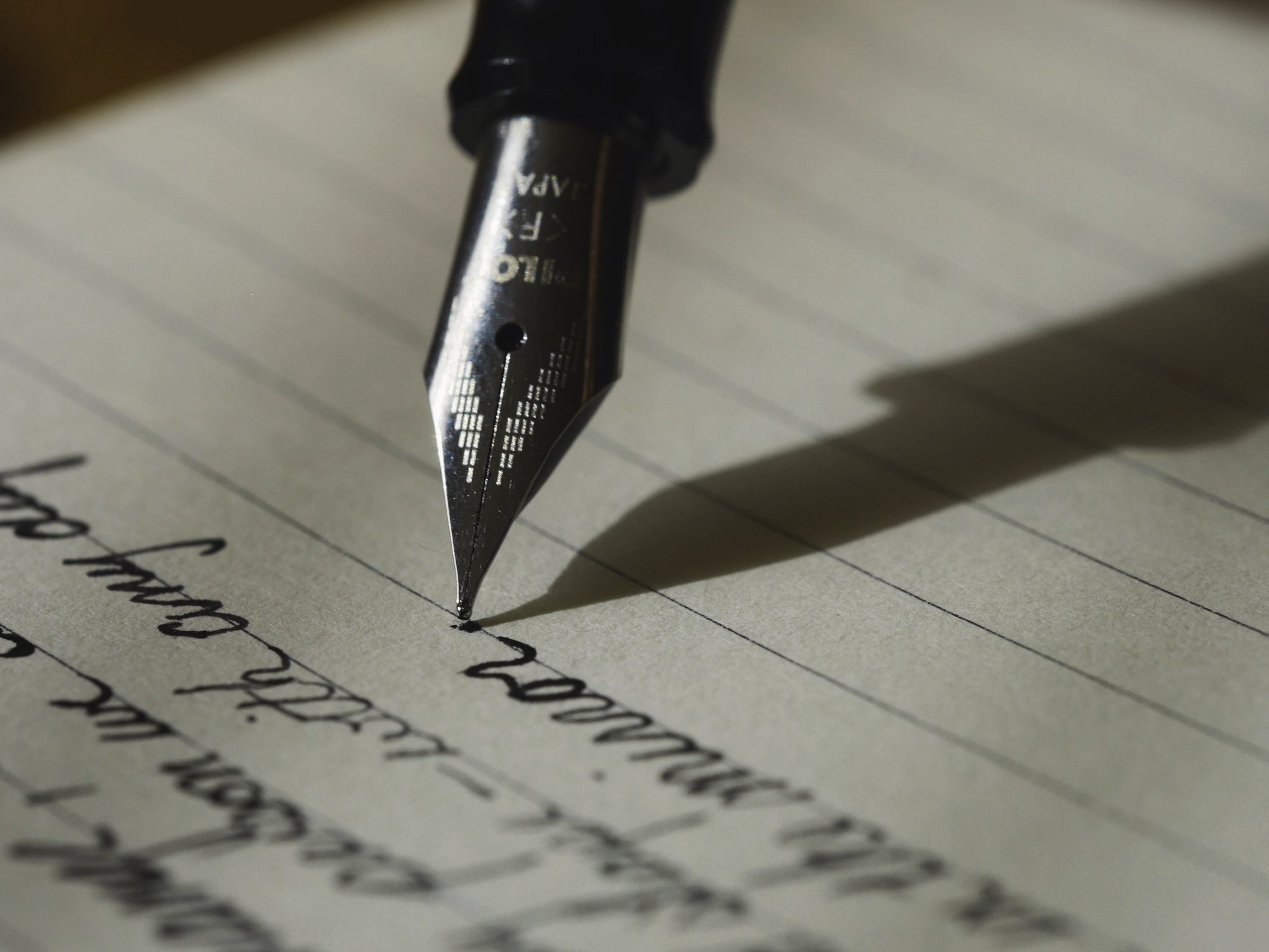 Fountain pen nib writing on paper